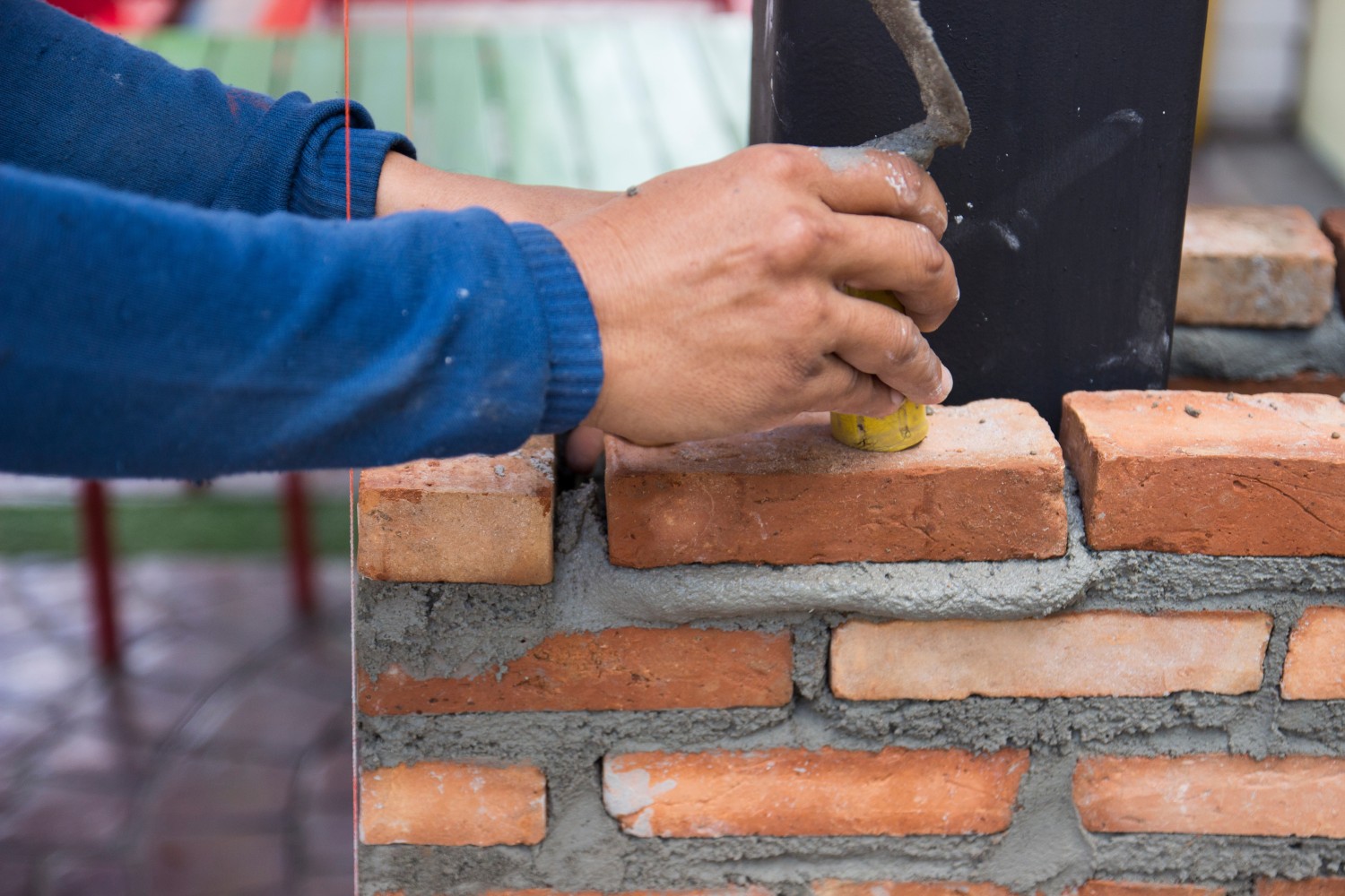 the worker is masoning the brick